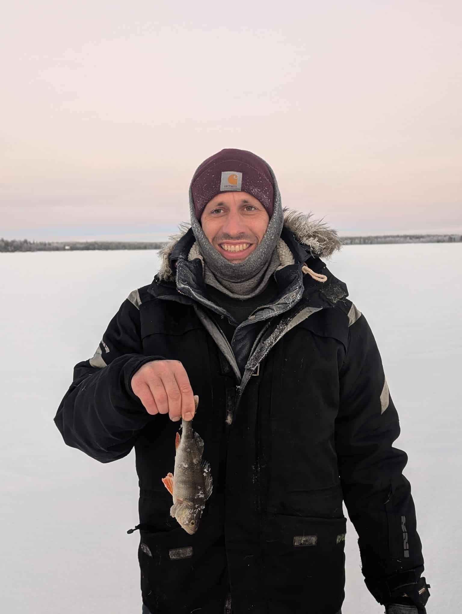 View over Lake Ylläsjärvi and ice fishing holes at sunset
