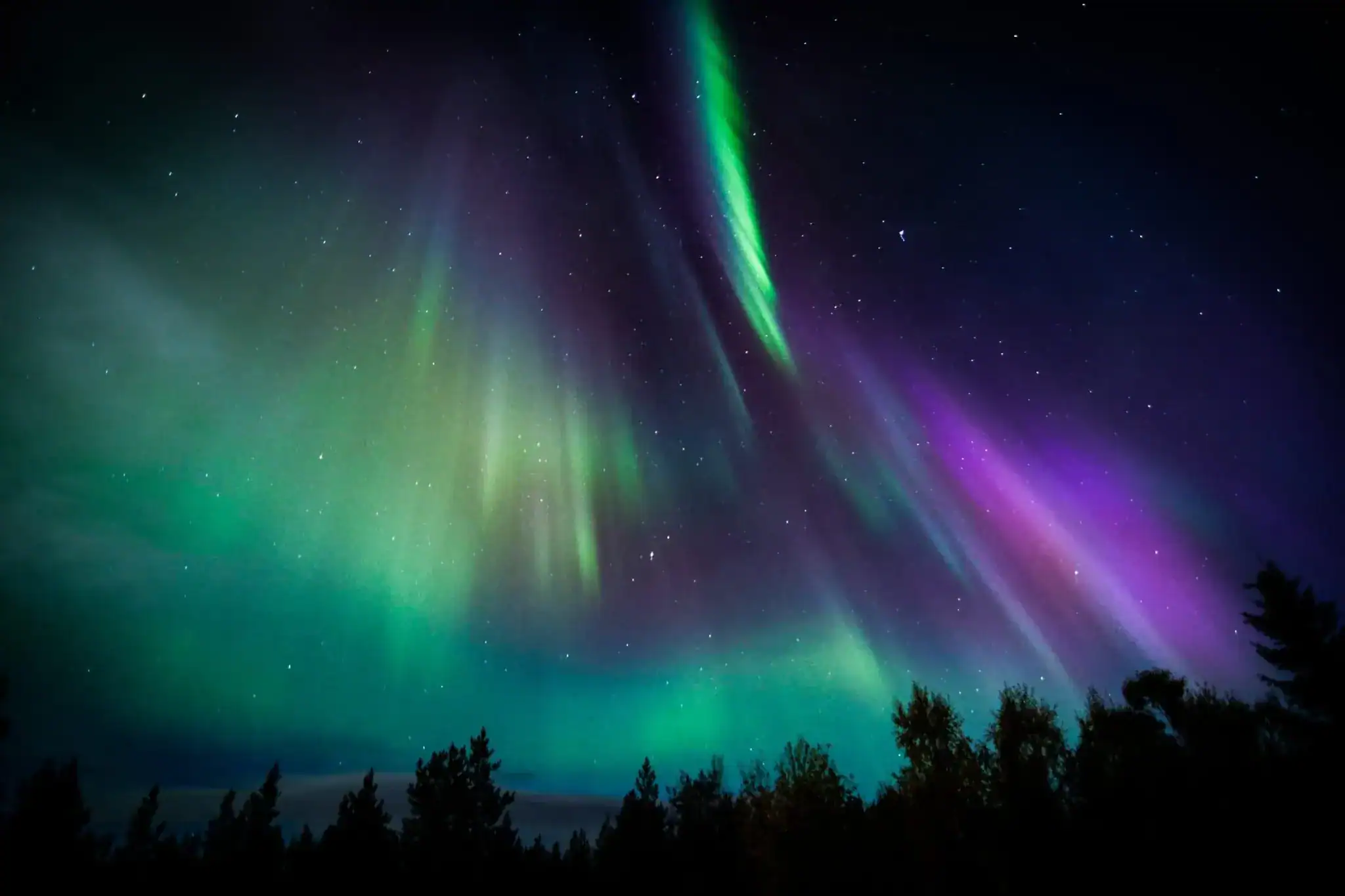 Aurora borealis illuminating the night sky in Finnish Lapland.