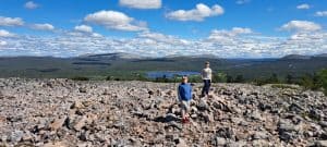 Children exploring rocky mountain landscape.
