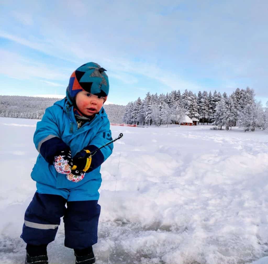 Child dressed up warmly for ice fishing