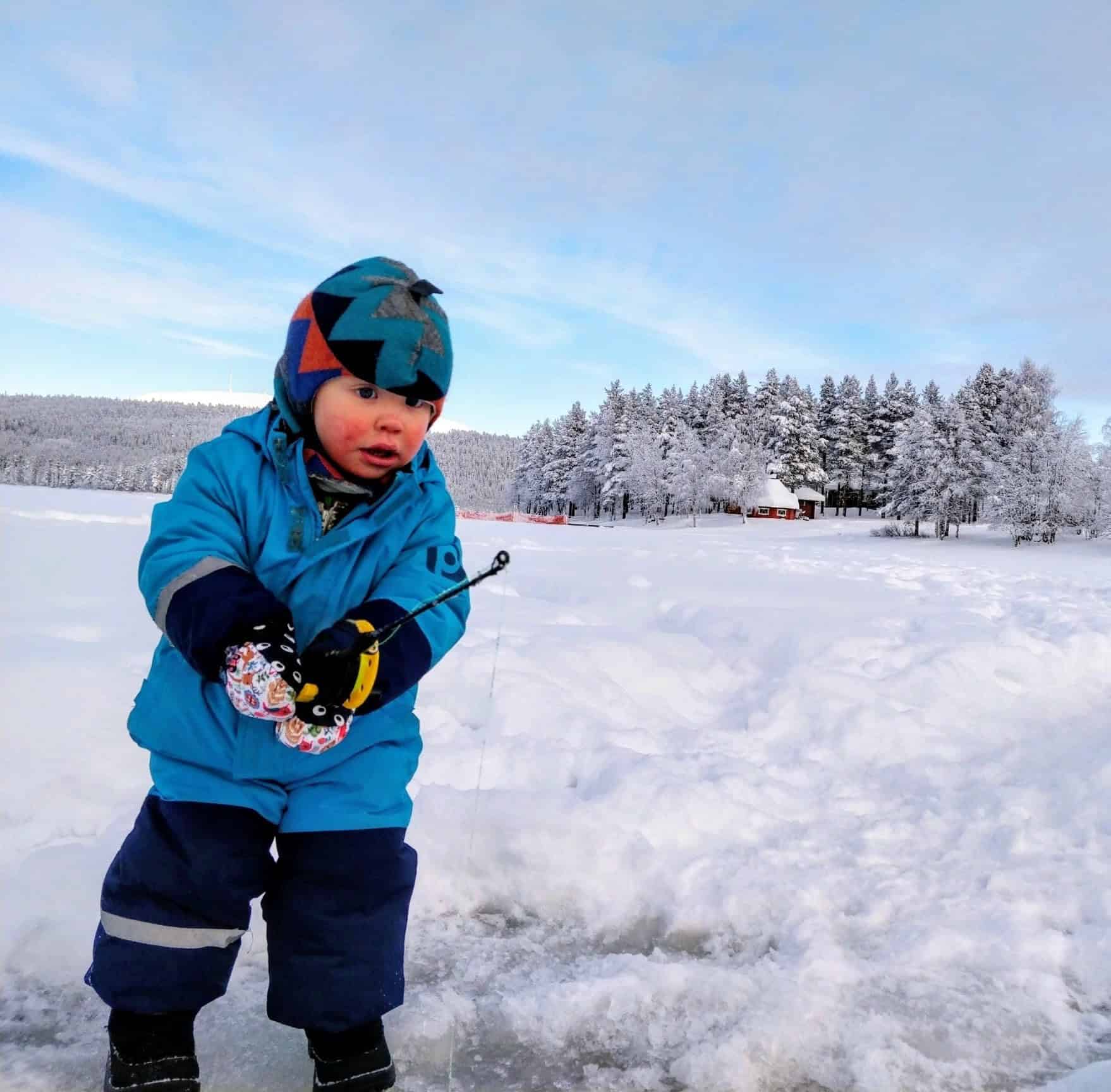 Child dressed up warmly for ice fishing